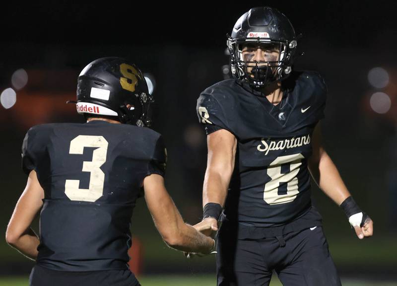 Sycamore's Diego Garcia is congratulated by teammate Carter York after scoring a touchdown during their game against Kaneland Friday, Sept. 29, 2023, at Sycamore High School.