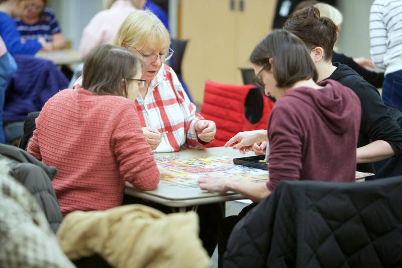 Teams compete in a 500 piece puzzle speed race competition on Saturday, Jan. 27,2024 at the Elmhurst Library in Elmhurst.