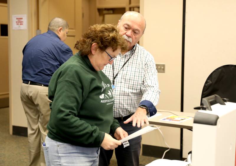 Mary Beth McLain of Batavia is shown how to use the new Hart Verity Duo voting equipment by Kane County Deputy Clerk Jim Morefield during a demonstration hosted by the Kane County Clerk’s Office at the Batavia Public Library on Wednesday, Nov. 8, 2023.
