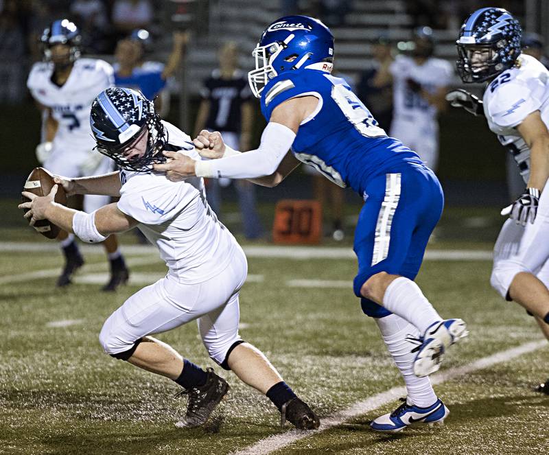 Bureau Valley’s Bryce Helms is held by the facemark by Newman’s Caleb Donna Friday, Sept. 29, 2023 in Sterling. Donna was called with a penalty.