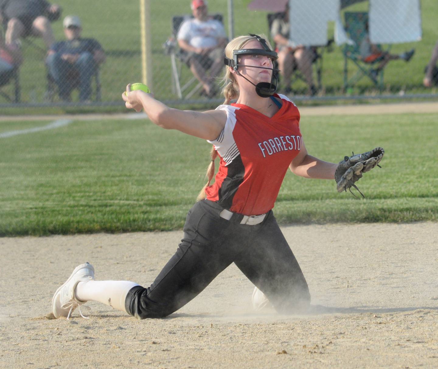 Forreston third baseman Rylee Broshous throws an Orangeville runner out from her knees during the 1A Forreston Sectional against Orangeville on Tuesday, May 23.