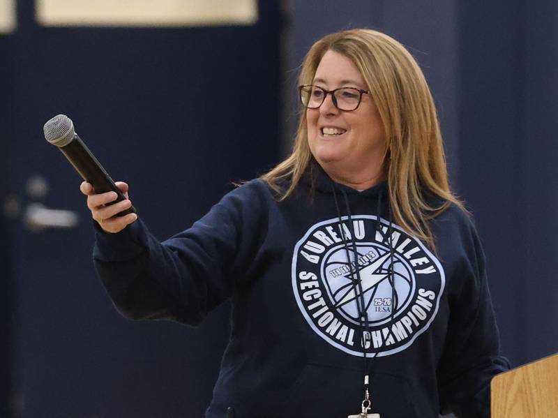 Bureau Valley Junior High principal Julie Platz smiles while passing gthe microphone off during a prep rally on Thursday, Dec. 11, 2025 at Bureau Valley High School in Manlius.