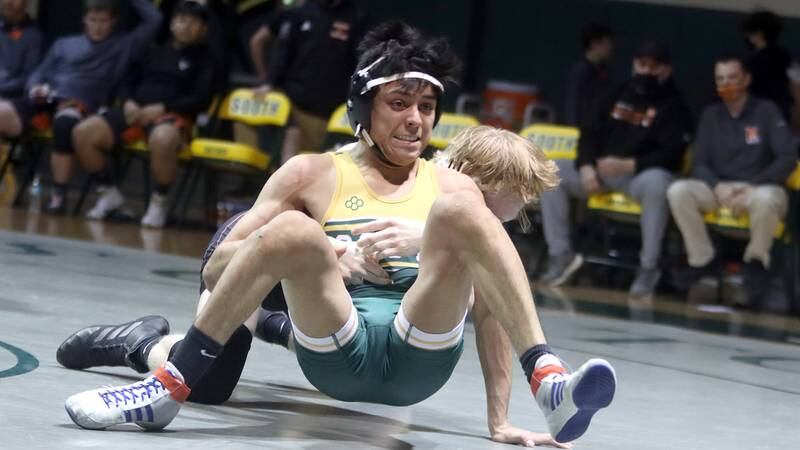 Crystal Lake South’s Alex Flores, front,  battles McHenry’s Justin Karcz  in a 138-pound match during varsity wrestling at Crystal Lake Thursday night.
