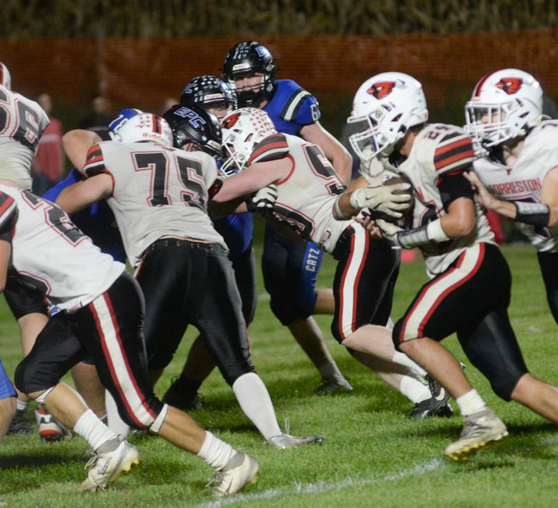 Forreston's Mickey Probst (34) runs with the ball as linemen Carter Fox (75) and Collin Bismark (50) block against Eastland-Pearl City during a game at Pearl City High School on Friday, Oct. 3, 2025.