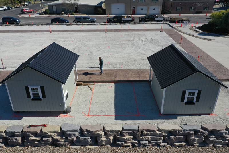 Crews move huts into the retail site plaza on Wednesday, Oct. 16, 2024 downtown Utica.