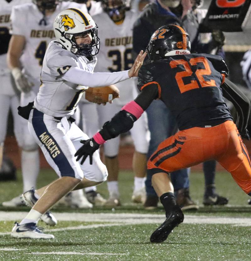 Neuqua Valley's Mark Mennecke tries to get by DeKalb's Aiden Sisson during their game Friday, Oct.14, 2022, at DeKalb High School. Mennecke was injured on the play.
