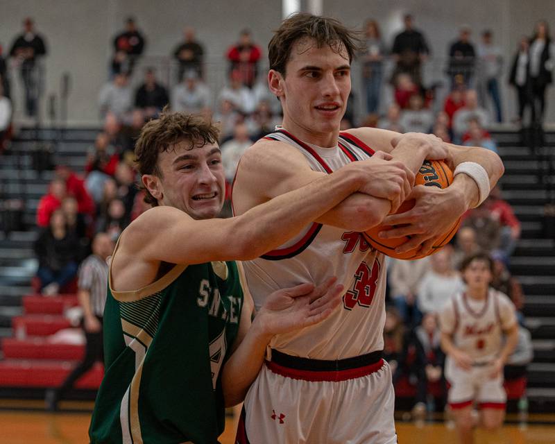 Hall's Braden Curran (33) hugs ball as Gino Ferrari (4) of St. Bede attempts to strip it out of his hands on Saturday, January 31, 2026 at Hall High School in Spring Valley.