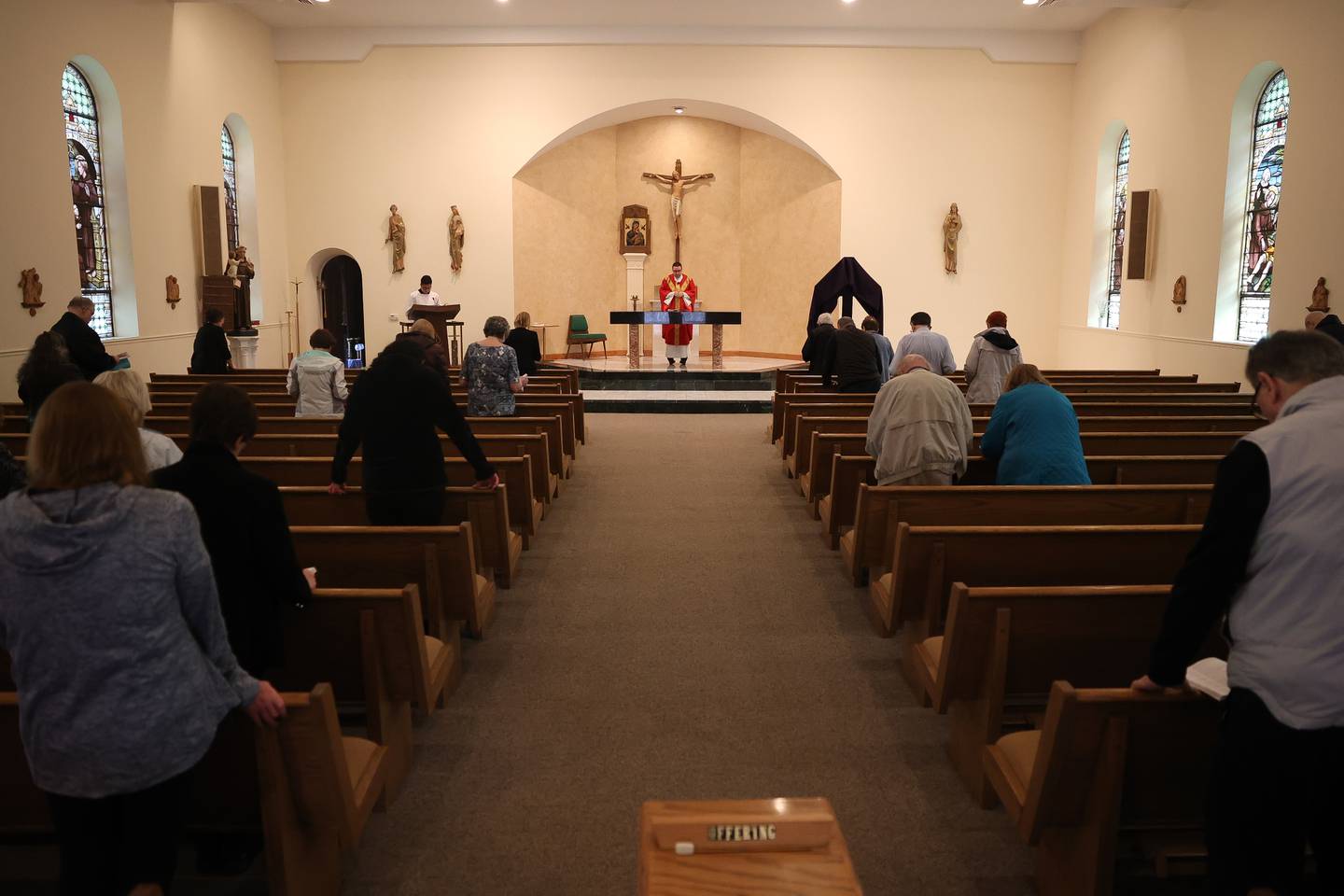 Father Jim Olofson leads mass at Church of St. Anthony on Friday, March 29, 2024 in Joliet.