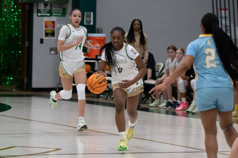 Bishop McNamara's Mahlyia Johnson brings the ball up during their game against Joliet Catholic on Wednesday, Feb. 11, 2026.