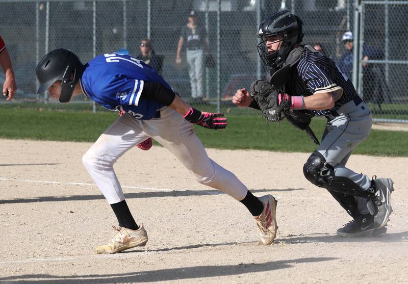 Hiawatha catcher Hunter Ziegler chases down Hinckley-Big Rock's Skyler Janeski who was caught in a rundown Tuesday, April 29, 2025, during their game at Hiawatha High School in Kirkland.