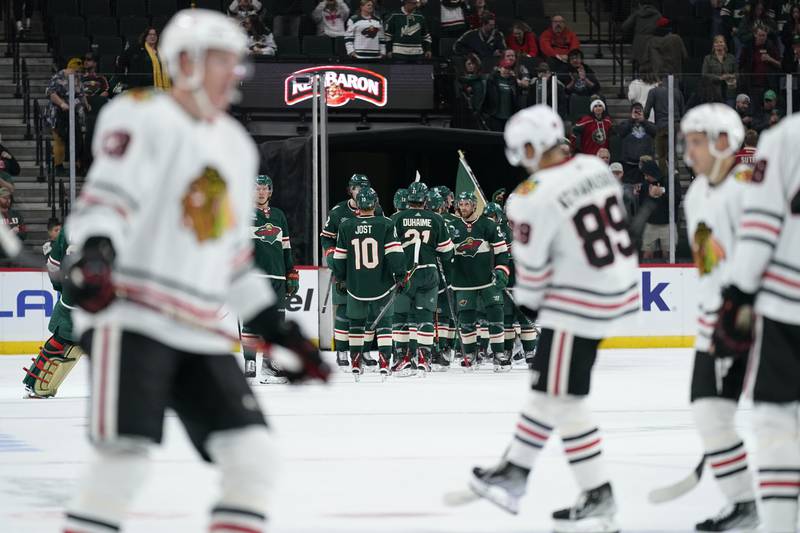 Minnesota Wild players celebrate after a win over the Chicago Blackhawks in an NHL preseason hockey game Thursday, Oct. 6, 2022, in St. Paul. (AP Photo/Abbie Parr)