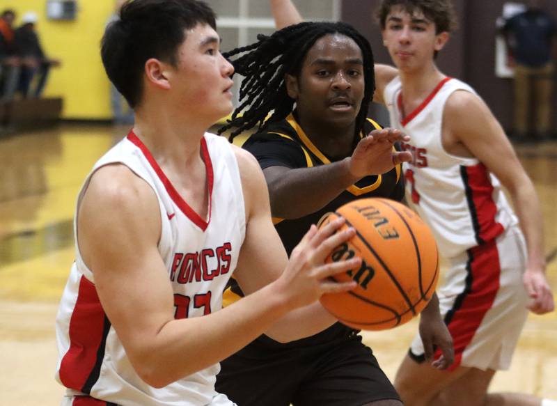 Jacobs’ Emaan Thomas, center, guards Barrington’s Bruce LeBlanc, left, during Hinkle Holiday Classic varsity boys basketball tournament action on Monday, Dec. 23, 2024 at Jacobs High School in Algonquin.
