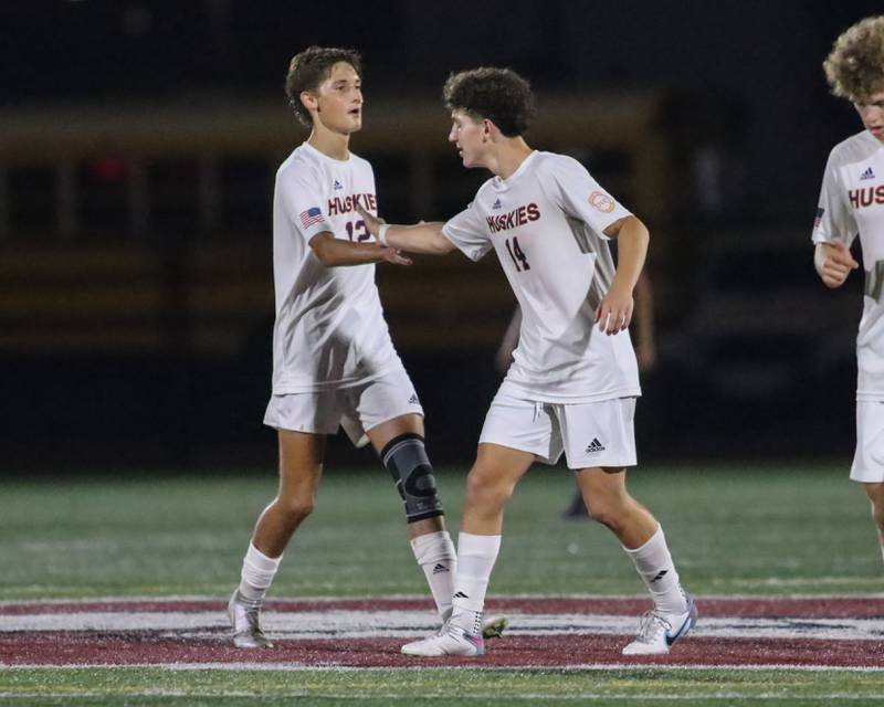 Naperville North's Niko Ladas (14) is greeted by Colin Mcmahon (12) after scoring a goal during soccer match between Naperville North at Morton.