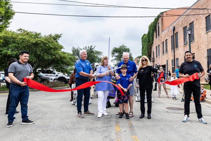 Representatives from the City of Joliet and Joliet Public Library, Juan Moreno, Mayor Terry D'Arcy, Megan Millen, Pat Mudron, Noah Mudron, Jan Hallums Quillman, and Cesar Cardenas cut the ribbon to kick-off Star Wars Day on June 7, 2025.