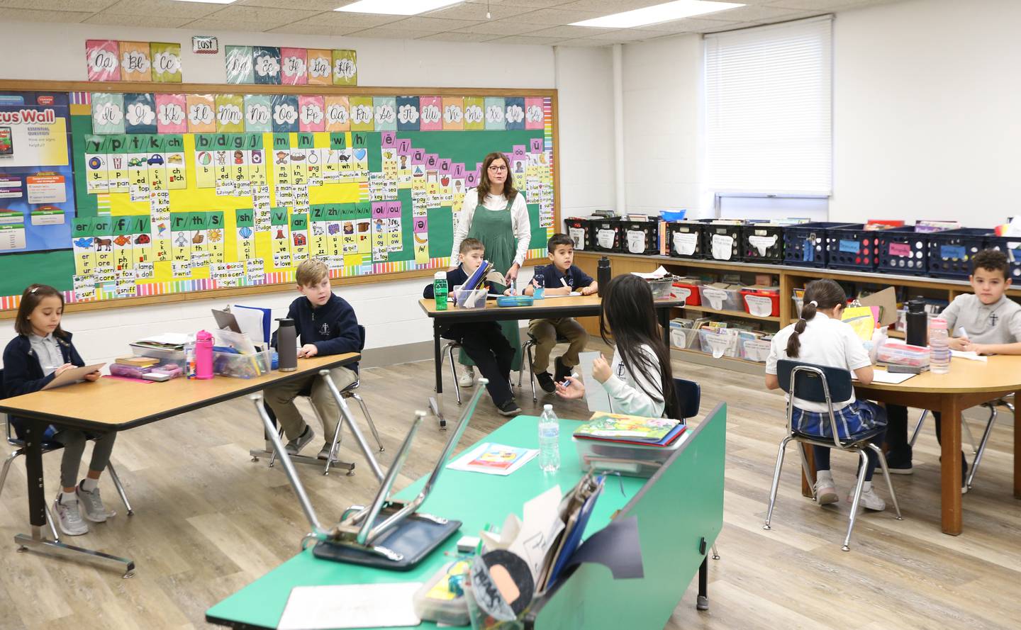 Mrs. Maggie Hachenberger teaches math to second grade students at Trinity Catholic Academy on Tuesday, Feb. 7, 2023, in La Salle.