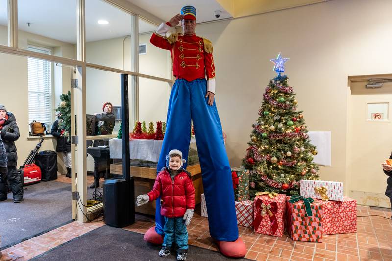 Lockport resident Theo Newhart takes a photo with Dave Fleming, dressed as a toy soldier, inside Lockport City Hall during Lockport’s Christmas in the Square festivities on Nov. 29, 2025.