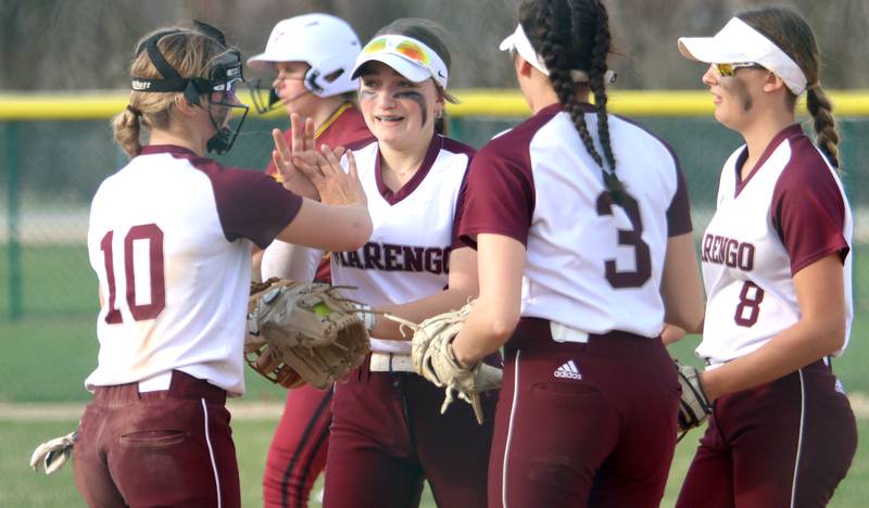 Marengo’s Gabby Christopher, center, is greeted by teammates after a play against Richmond-Burton in varsity softball at Marengo Tuesday.