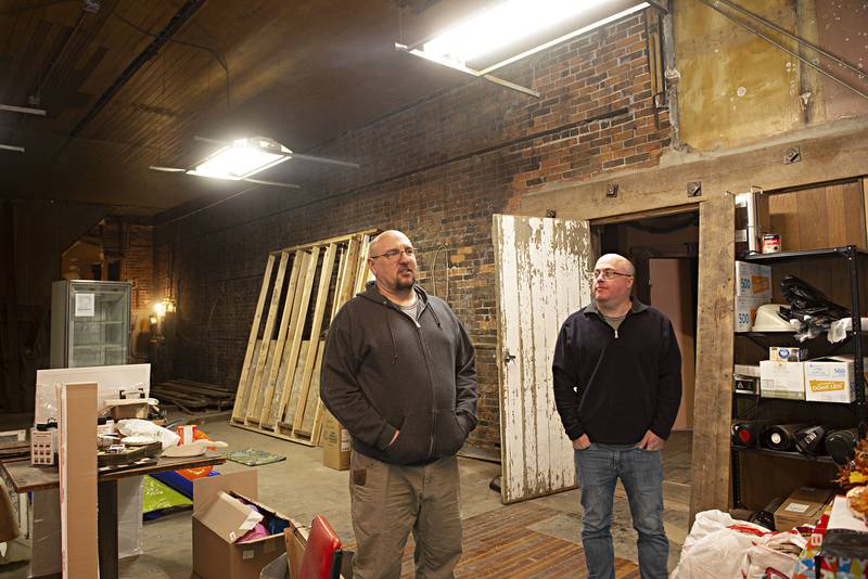 Developers Brian Carradus (left) and Kurt Studnicki talk about their plans after purchasing the  former Beans, Books and Beliefs and Haymarket buildings in downtown Sterling. A restaurant will be going into the Beans side, possible retail space in the former bar and apartments back upstairs.