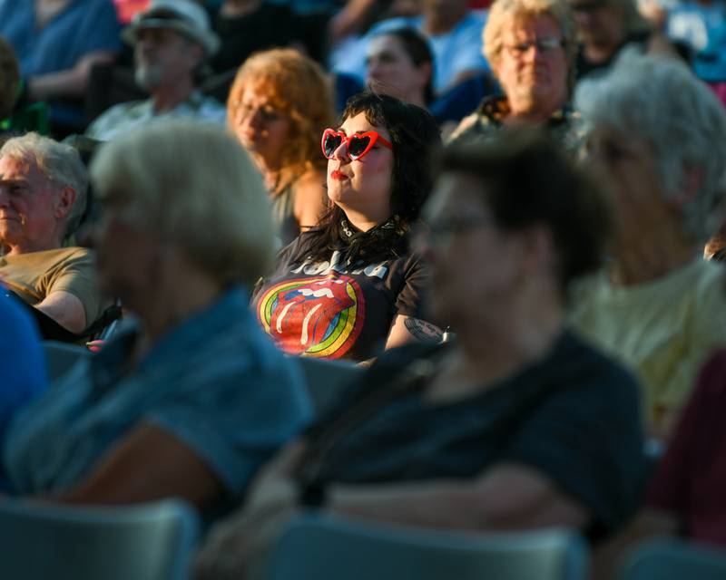 Rosie Filcicchia is decked out in Rolling Stones gear as she listens to Second Hand News a Chicago-based Fleetwood Mac tribute band on Friday Aug. 2, 2024, before Rocks Off: A Tribute to The Rolling Stones preform at Memorial Park in Wheaton.