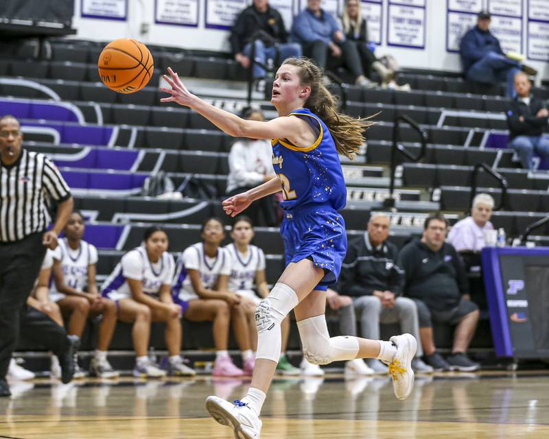 Johnsburg's Skye Toussaint (32) reaches for a loose ball during their basketball game between Johnsburg at Plano, Monday Dec 16, 2024 in Plano.