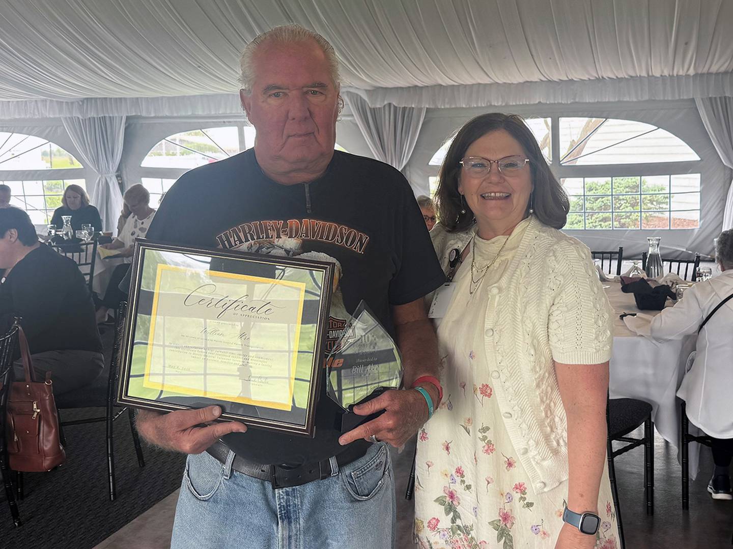 Volunteer William Akre (left) was honored for 40 years of volunteer service by Morris Hospital Patient Transportation Manager Tina Carter.