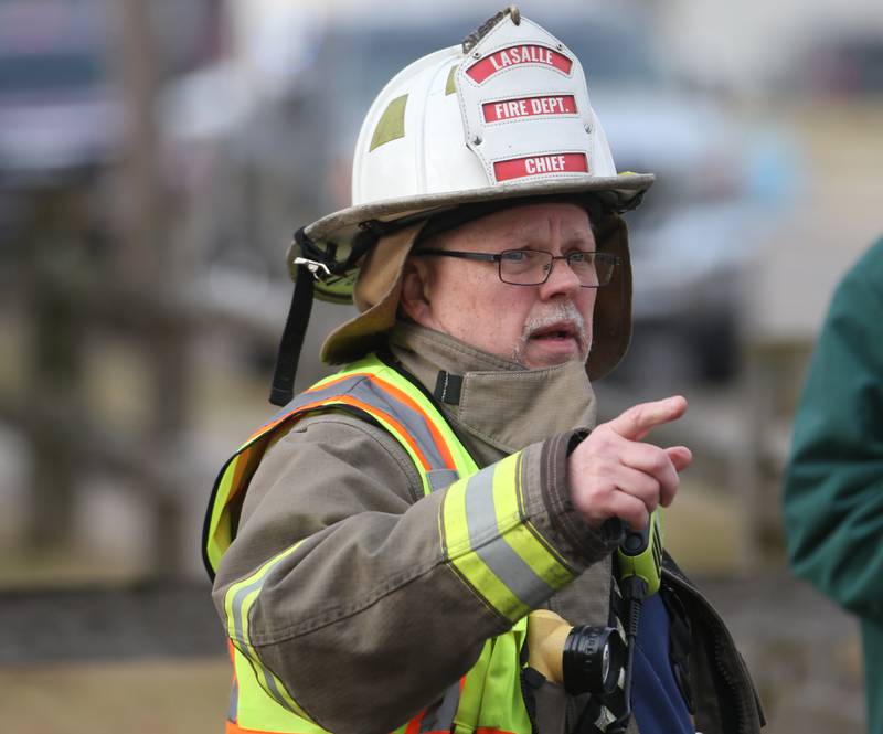 La Salle fire chief Jerry Janick points to the scene of a massive fire at Carus Chemical on Wednesday, Jan. 11, 2023 in La Salle.