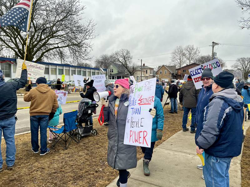 Mary McCormick leads the crowd in a chant during a protest against President Donald Trump and his administration on Friday, March 7, 2025, in Sterling, Illinois.