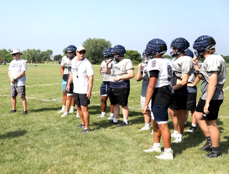 Oswego East players run drills during a joint practice with Glenbard South and Sterling football teams on Tuesday, July 15, 2025 in Oswego.