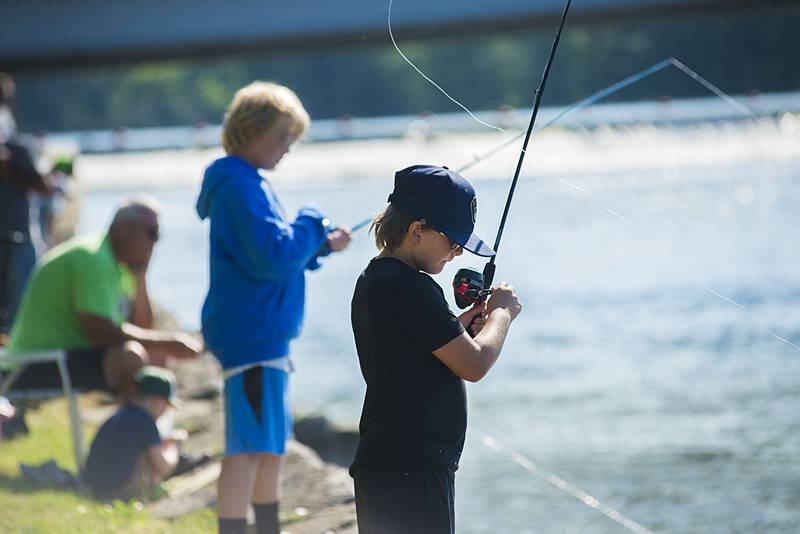 Griffin White, 8, of New Mexico, casts a line during a kids fishing derby as part of Petunia Fest Saturday, July 2, 2022. The event took place between the bridges.