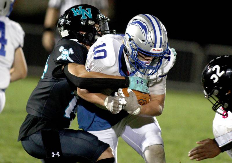 Woodstock North’s Dillon Morrison, left, wraps up Woodstock’s  Landen Stoltz in varsity football at Woodstock North Friday night.