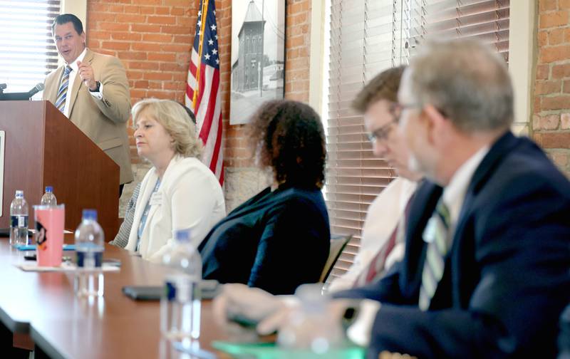 The panel listens as Brian Gregory, DeKalb County administrator, speaks during the State of the Community address Thursday, May 11, 2023, in the DeKalb County Community Foundation Freight Room in Sycamore. The event was hosted by the Sycamore Chamber of Commerce.