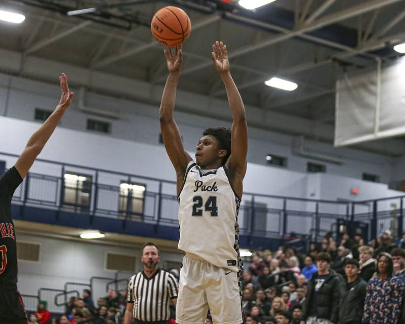 Oswego East's Dshaun Bolden (24) shoots a jumper during their basketball game between Yorkville at Oswego East. Friday, Dec 19, 2025 in Oswego.