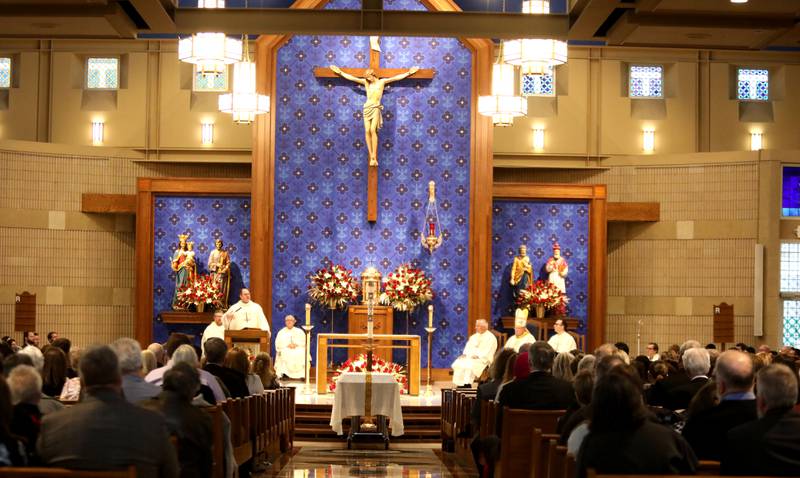 Reverend Jared Twenty, pastor of Holy Cross Catholic Church in Batavia, gives the homily for Reverend Jonathan Bakkelund during the Mass of Christian Burial at St. Peter Catholic Church in Geneva on Wednesday, Jan. 31, 2024.