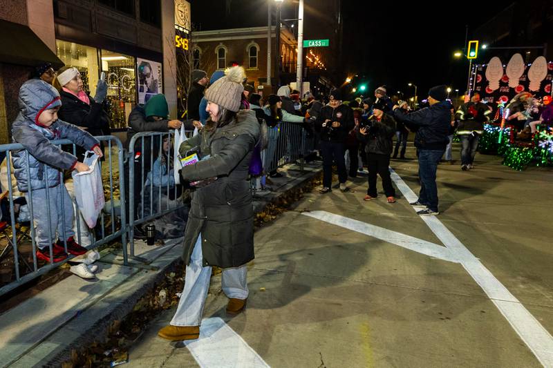 Representatives from the Joliet Fire Department hand-out candy to spectators during the Light Up the Holidays Parade in Downtown Joliet on Nov. 28, 2025.