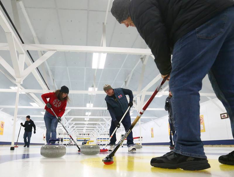 (From left) Marianne Kuhn, of Naperville, Marty Allen, of Ottawa, and Robert Mortensen, of Somonauk, curl at the Waltham Curling Club on Saturday Jan. 22, 2022 in Triumph. The building was built in the 1940's. The club was founded in 1884 and is the oldest curling club in Illinois. The club welcomes all levels of experience including men’s, women’s, junior's and mixed leagues as well as bonspiels, open events and instructional sessions.