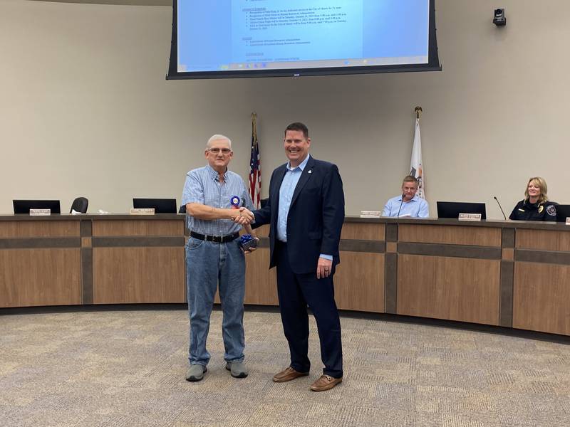 Ortha King, Jr. shakes hands with Morris Mayor Chris Brown. King retired from the City of Morris after 51 years on Monday.
