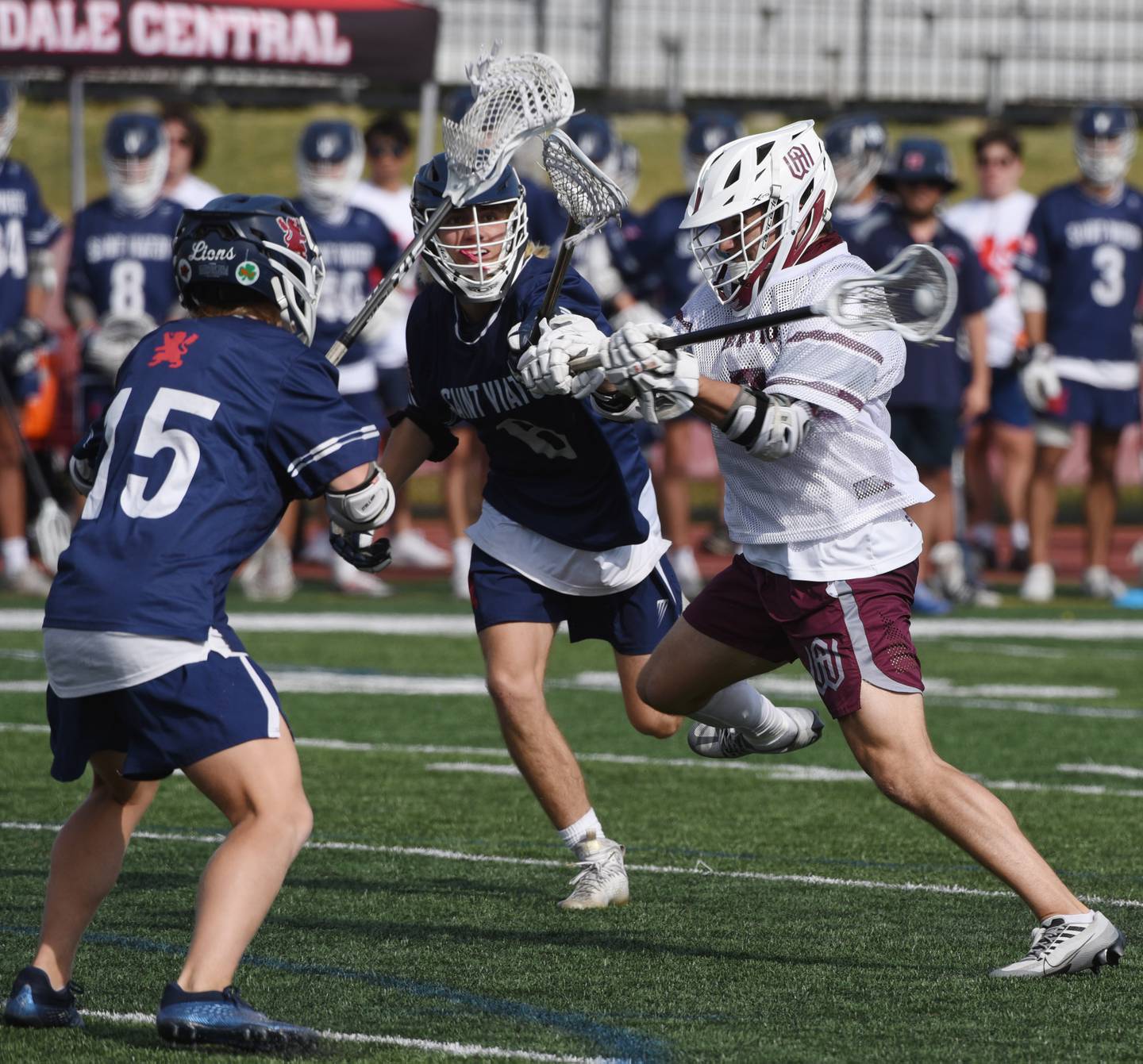 Joe Lewnard/jlewnard@dailyherald.com
Wheaton Academy’s Breck Peacock, right, goes hard toward the net for a goal against St. Viator defenders including Emerson McGrath, left, during the boys state lacrosse championship in Hinsdale Saturday.