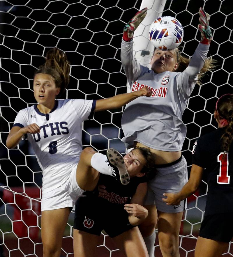 Barrington's Megan Holland grabs the ball out of the air over her teammate Piper Lucier during the IHSA Class 3A state championship match at North Central College in Naperville on Saturday, June 3, 2023.