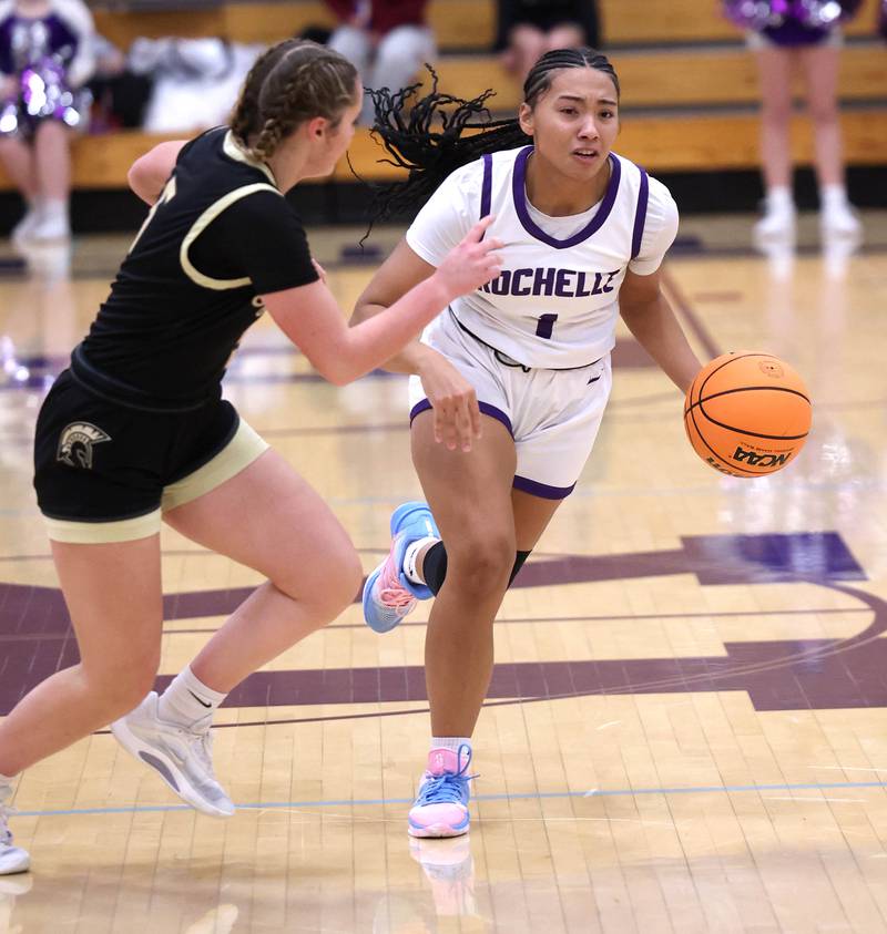 Rochelle's Carmela Bright drives against Sycamore's Grace Amptmann Friday, Dec. 5, 2025, during their game at Rochelle High School.