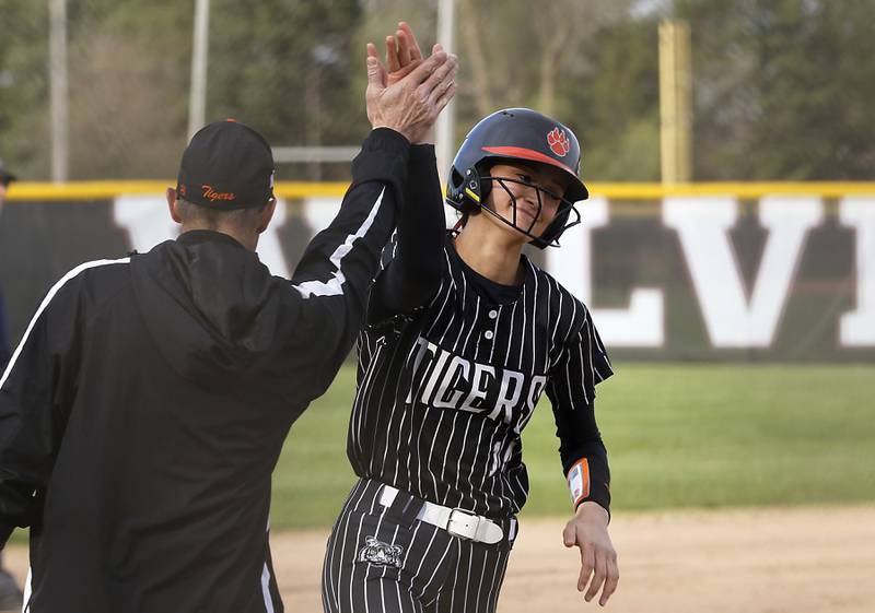 Crystal Lake Central's Lily Perocho is congratulated by coach Brian Strombom after hitting a two-run home run during a Fox Valley Conference softball game against Prairie Ridge on Monday, April 20, 2026, at Prairie Ridge High School.