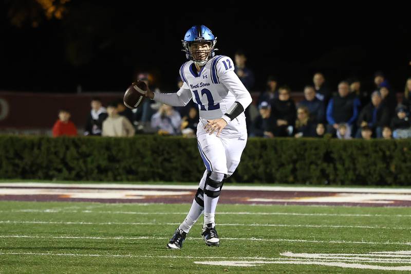 St. Charles North's J.T. Padron rolls out of the pocket to pass against Brother Rice in the third round of the playoffs on Saturday, Nov. 15, 2025 in Chicago.