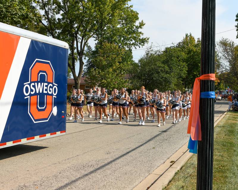 Oswego High School dance team participates in the homecoming parade on Sunday Sept. 15, 2024, as orange and blue ribbons line the parade route to honor a student who lost their life in a car crash.