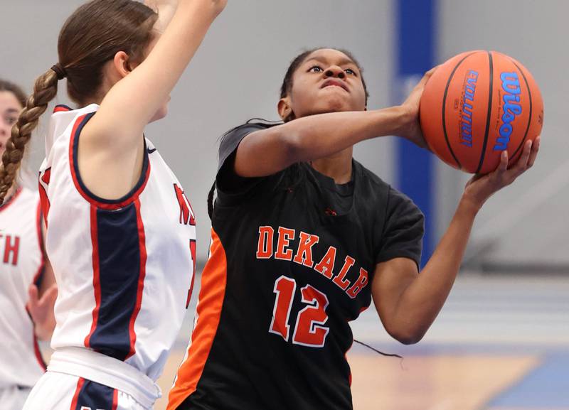DeKalb’s Brytasi Long goes to the basket against Belvidere North's Camryn Diercks during their game Friday, Nov. 17, 2023, in the Mark Einwich Varsity Girls Basketball Rockets Kickoff Tournament at Burlington Central High School.