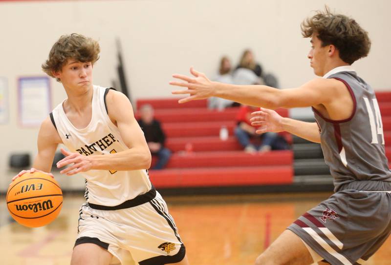 Putnam County's Brayden Zunga looks to pass the ball around Illinois Valley Central's Keegan Schol during the 50th annual Colmone Classic on Thursday, Dec. 12, 2024 at Hall High School.