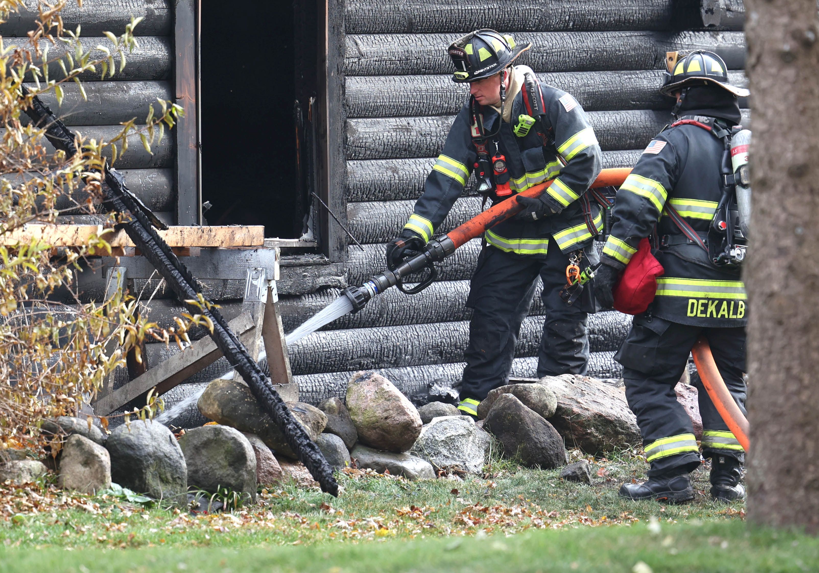 DeKalb firefighters put out a hotspot on a house that was destroyed by fire Thursday, Nov. 13, 2025, near Shabbona Grove Road in Shabbona. Several local departments responded to the general alarm structure fire.