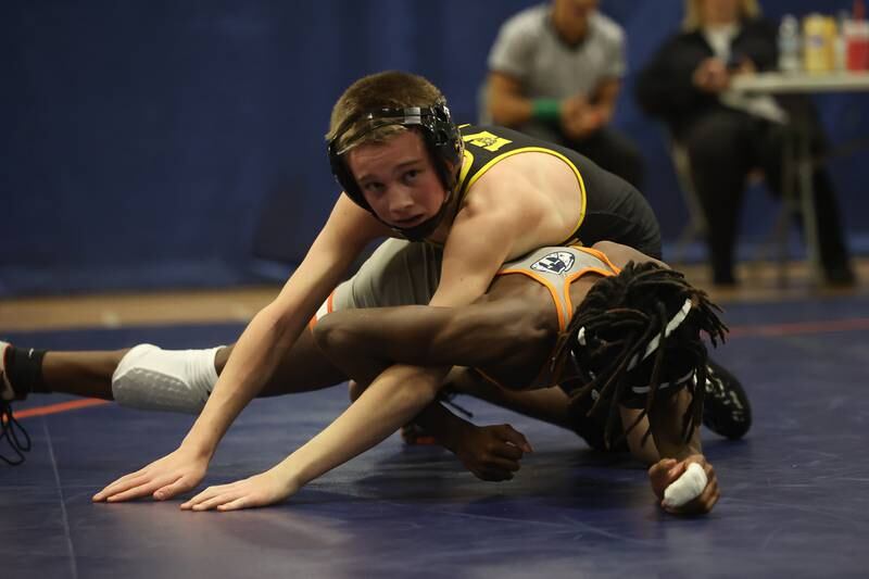 Joliet West’s Jakob Candall looks to the referee for the match winning two points in the final seconds against Romeoville’s Savion Essiet in a dual meet on Thursday, Dec.14th, 2023 in Romeoville.