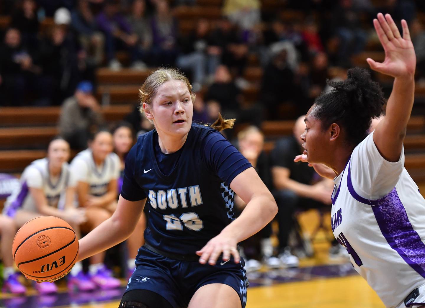 Downers Grove South’s Megan Ganschow starts to pass as she is defended by Downers Grove North’s Elizabeth Murphy during a game on December 20, 2025 at Downers Grove North High School in Downers Grove.