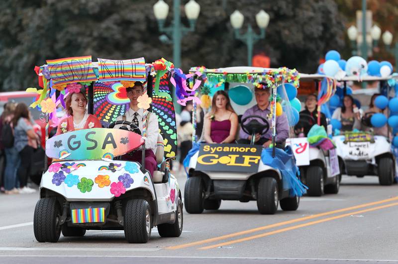 The colorfully decorated golf carts from the student groups at Sycamore High School make their way through downtown Wednesday, Oct. 5, 2022, during the school's homecoming parade.
