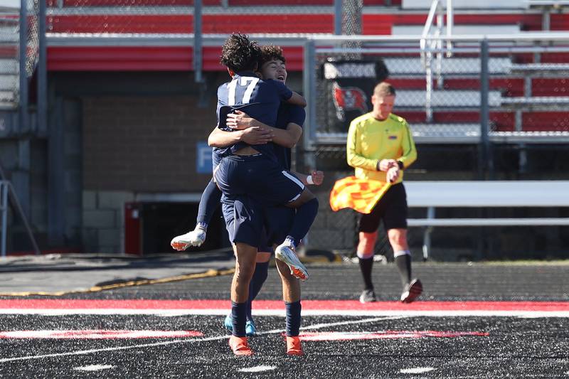 West Aurora’s Sujan Tiwari jumps into the arms of Kevin Soto at the whistle in their 2-1 win over Bolingbrook in the Class 3A Bolingbrook Regional championship match on Saturday, Oct. 26, 2024 in Bolingbrook.