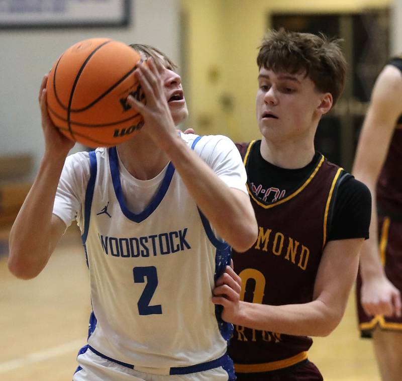Woodstock's Collin Stock looks to shoot agains the defense of Richmond-Burton's Gavin Radmer during a Kishwaukee River Conference boys basketball game on Wednesday, February. 4, 2026, at Woodstock High School.